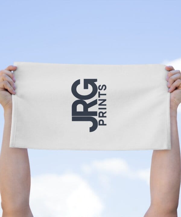 Custom logo rally towel held up at a game